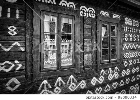 Reflection in windows on cottage with ornament paint in UNESCO village Cicmany, Slovakia Reflection in windows on cottage with ornament paint in UNESCO village Cicmany, Slovakia 98090334