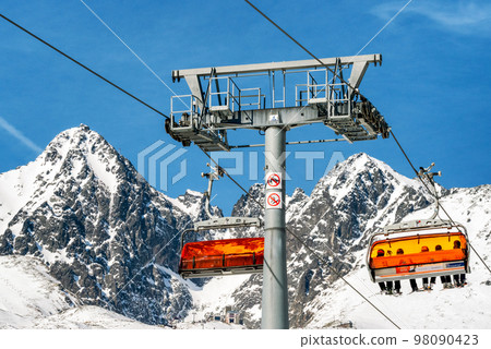 Ski lift and peak Lomnicky stit in High Tatras mountains in resort Tatranska Lomnica, Slovakia 98090423