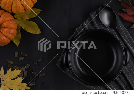 Dark plate and napkin on dark background in autumn style. Dark plate and napkin on dark background in autumn style. 98090724
