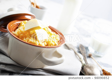 porridge with butter in plate on rustic table porridge with butter in plate on rustic table 98090852