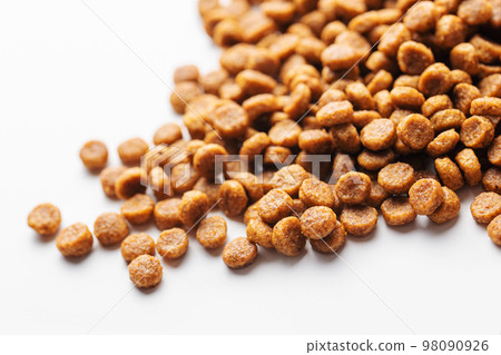 Dry feed pellets for dogs on a white background. Dry feed pellets for dogs on a white background. 98090926