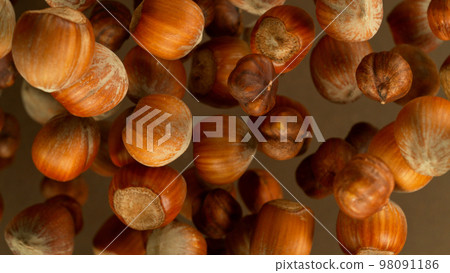 Freeze Motion Shot of Flying Whole Hazelnuts, Close-up Freeze Motion Shot of Flying Whole Hazelnuts, Close-up 98091186