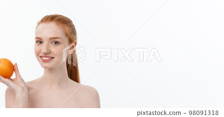 Portrait beautiful woman with a orange isolated. 98091318