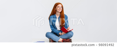 Dreamy and creative cute diligent female student with red hair, in glasses, sitting on floor with legs crossed surrounded by notebooks writing something, creating poem, look up thoughtful Dreamy and creative cute diligent female student with red hair, in glasses, sitting on floor with legs crossed surrounded by notebooks writing something, creating poem, look up thoughtful 98091492