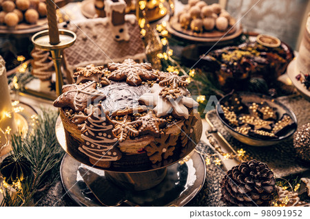 Fancy table fulfilled with Christmas desserts 98091952