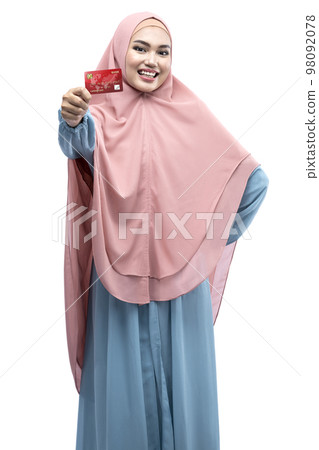 Asian Muslim woman in veil holding credit card and shopping bags Asian Muslim woman in veil holding credit card and shopping bags 98092078