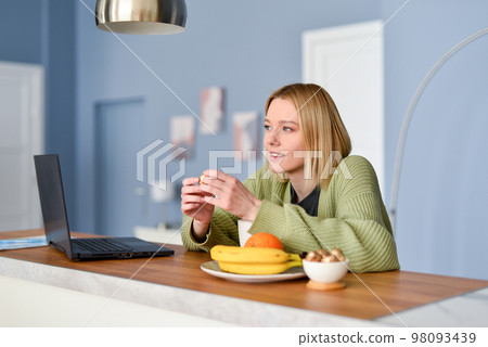 Young woman having breakfast or lunch at home Young woman having breakfast or lunch at home 98093439