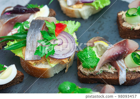 Appetizer with salted herring. 98093457