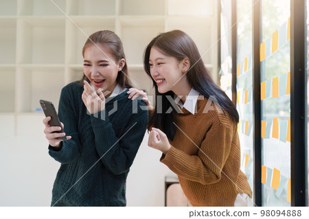 Asian Business People feels excited celebrating and working together success business goal 98094888