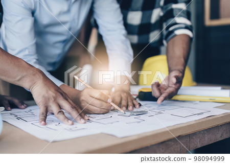 Professional architect designer structural engineer team colleagues discussing building plan design project Professional architect designer structural engineer team colleagues discussing building plan design project 98094999