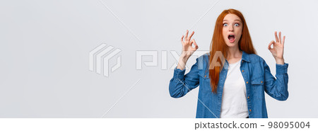 Amused, excited and thrilled good-looking redhead female in denim shirt, open mouth, drop jaw speechless staring with popped eyes camera, showing okay gesture in approval, white background Amused, excited and thrilled good-looking redhead female in denim shirt, open mouth, drop jaw speechless staring with popped eyes camera, showing okay gesture in approval, white background 98095004