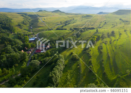 Flying over a village in Transylvania, Romania by drone 98095151