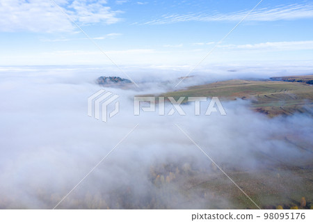 Aerial drone shot of flying above clouds Aerial drone shot of flying above clouds 98095176
