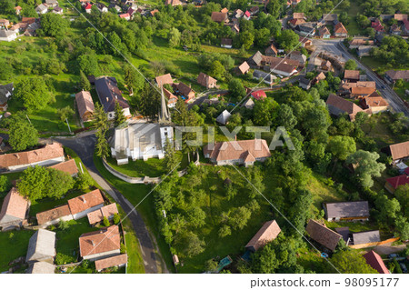 Aerial drone point of view of a whitewashed protestant church 98095177