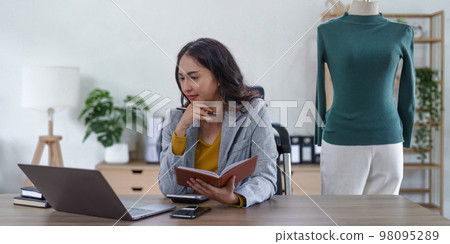 Asian Woman fashion designer cloth tailor creative working for new collection. Happy online store owner preparing an order for shipping. 98095289