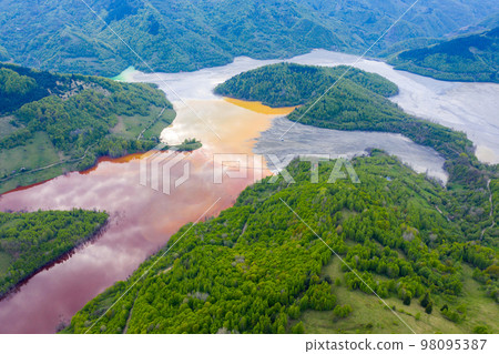 Aerial view of a big waste decanting lake 98095387