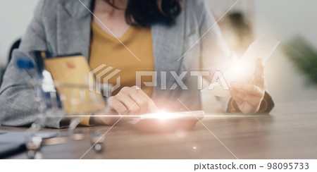 Young Asian Woman checking bills, bank account balance, taxes and calculating expenses at home Young Asian Woman checking bills, bank account balance, taxes and calculating expenses at home 98095733