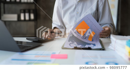 Asian Business woman working at home office and analyze financial report document. Accounting and Finance concept Asian Business woman working at home office and analyze financial report document. Accounting and Finance concept 98095777