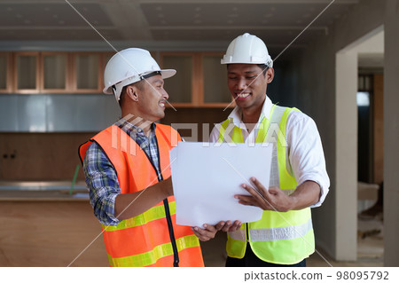 Professional architect designer structural engineer team colleagues discussing building plan design project 98095792