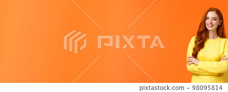 Business, e-commerce and people concept. Modern student, redhead girl learn IT, digital design in college, cross arms over chest with confident, assertive posture, smiling happy, orange background Business, e-commerce and people concept. Modern student, redhead girl learn IT, digital design in college, cross arms over chest with confident, assertive posture, smiling happy, orange background 98095814
