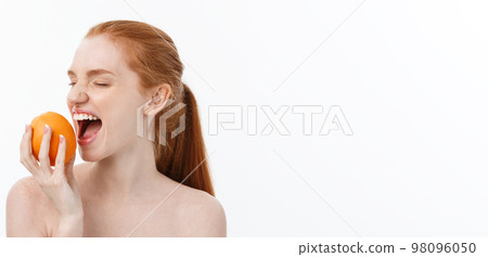 Portrait beautiful woman with a orange isolated. 98096050