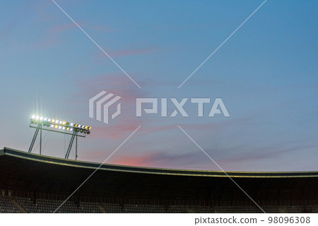 Stadium lights against blue sky Stadium lights against blue sky 98096308