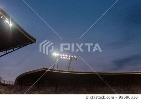 Stadium lights against blue sky 98096310