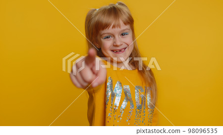 Amused child girl kid pointing finger to camera, laughing out loud funny ridiculous joke reaction 98096535