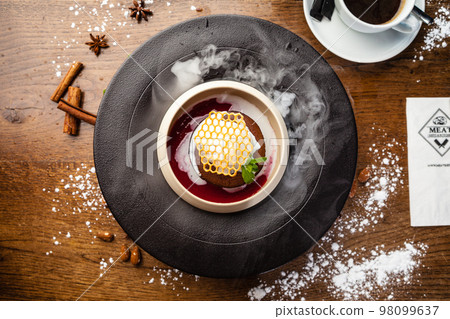 Chocolate fondant. Dark chocolate, raspberry sauce, vanilla ice cream dessert. Delicious healthy traditional food closeup served for lunch in modern gourmet cuisine restaurant 98099637