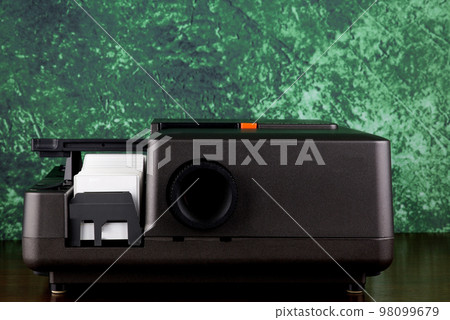 Old 35mm Slide Projector on a Polished Wooden Table Top Old 35mm Slide Projector on a Polished Wooden Table Top 98099679