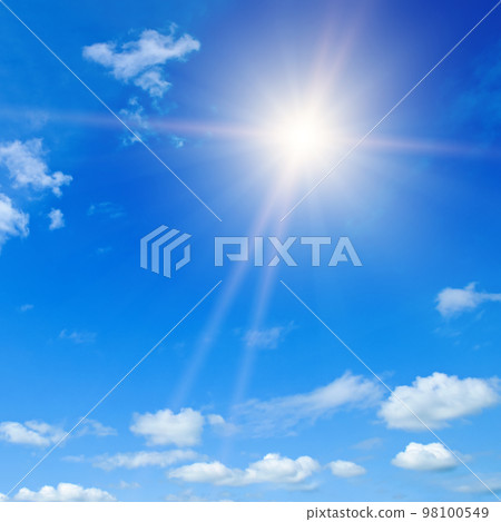 Blue sky , sun and beautiful white clouds. 98100549