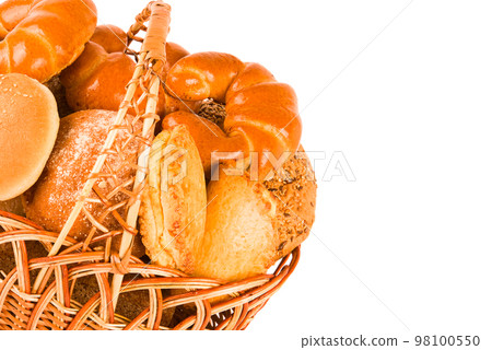 Sweet pastries in a basket isolated on a white . Free space for text. 98100550