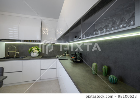 Dark grey counter counter top at white trendy kitchen 98100628