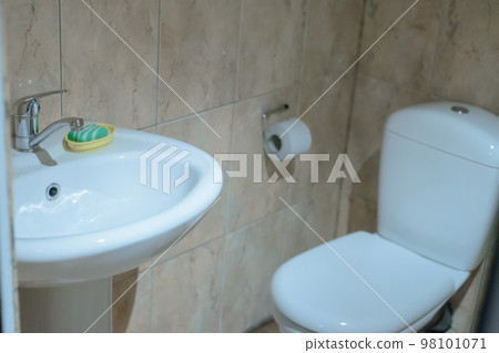 bathroom in a village house with a white toilet, sink and soap bathroom in a village house with a white toilet, sink and soap 98101071