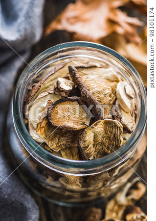 Sliced dried mushrooms in jar. Sliced dried mushrooms in jar. 98101174