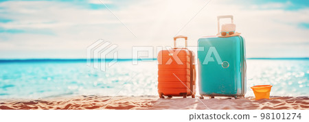 Panoramic view of the seacoast with suitcases on the sandbeach. 98101274