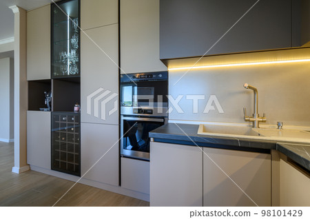 Large modern grey luxurious kitchen and dining room in studio apartment Large modern grey luxurious kitchen and dining room in studio apartment 98101429