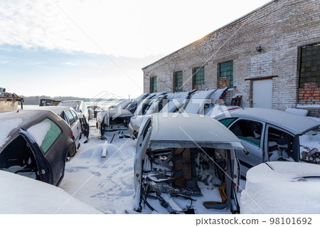 Disassembled cars on a car dump are on sale for spare parts. 98101692