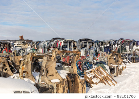 Disassembled cars on a car dump are on sale for spare parts. Disassembled cars on a car dump are on sale for spare parts. 98101706