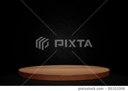 Round piece of wood on black background. MOCK-UP 98102006