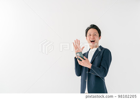 Businessman surprised smartphone middle man 98102205