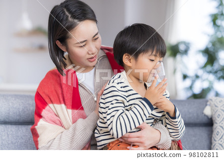 Boy inhaling asthma with a nebulizer Boy inhaling asthma with a nebulizer 98102811
