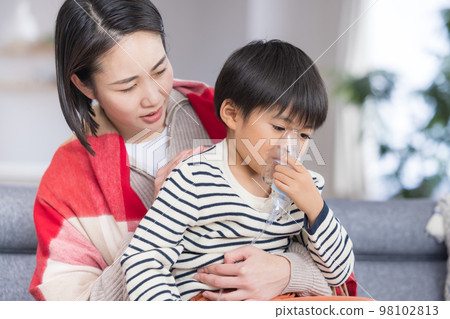 Boy inhaling asthma with a nebulizer Boy inhaling asthma with a nebulizer 98102813