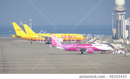 Cargo airliner and Peach on the tarmac Cargo airliner and Peach on the tarmac 98103435
