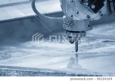Close-up scene of multi-axis abrasive waterjet cutting machine cutting the aluminum plate. Close-up scene of multi-axis abrasive waterjet cutting machine cutting the aluminum plate. 98104304