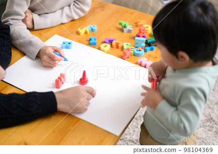 A family playing with drawings and alphabet puzzles　 98104369