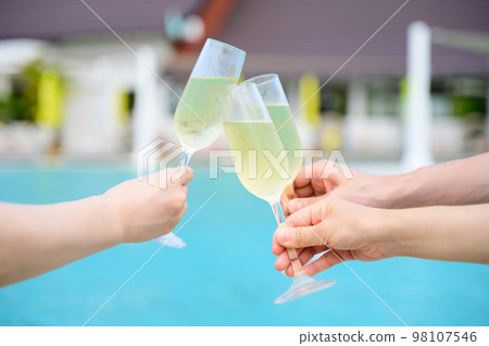 A tropical resort vacation toasting with champagne 98107546