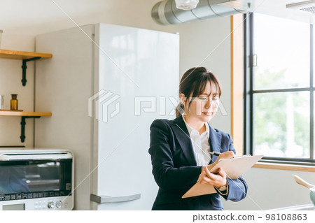 Asian business woman doing kitchen equipment and home diagnosis 98108863
