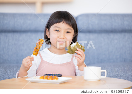 Girl eating Japanese sweets Girl eating Japanese sweets 98109227