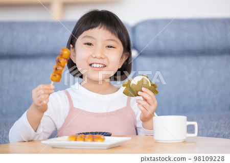 Girl eating Japanese sweets Girl eating Japanese sweets 98109228